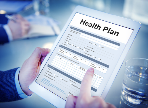 Picture of a man holding a smart tablet that says:

Health Plan