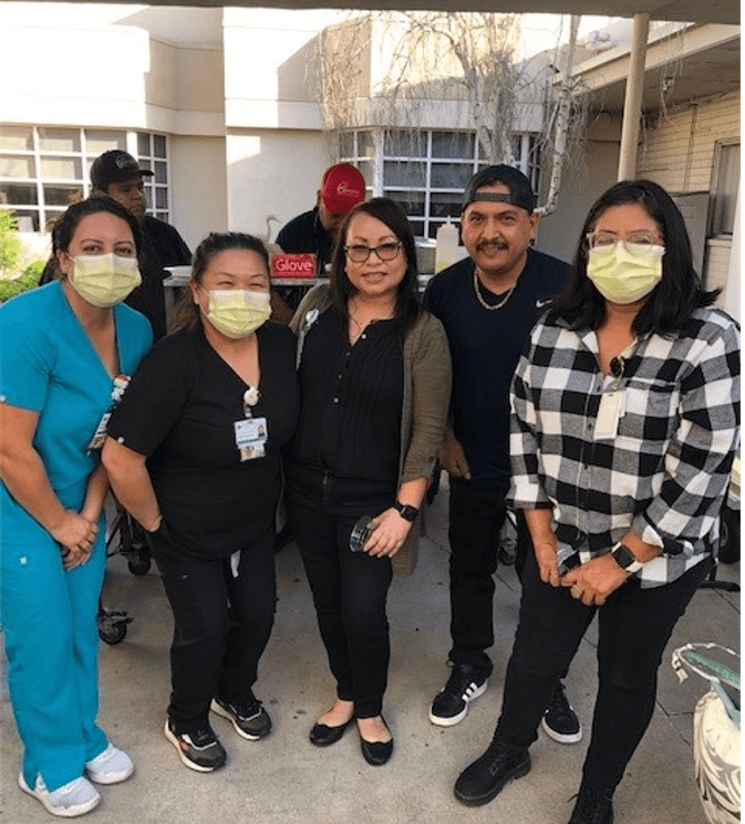 Whittier Staff taking a picture outside during Diana's Family Appreciation Dinner