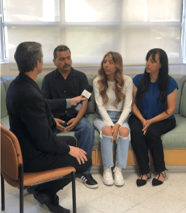 Diana's family (mom, dad, and sister) sitting down on a couch being interviewed