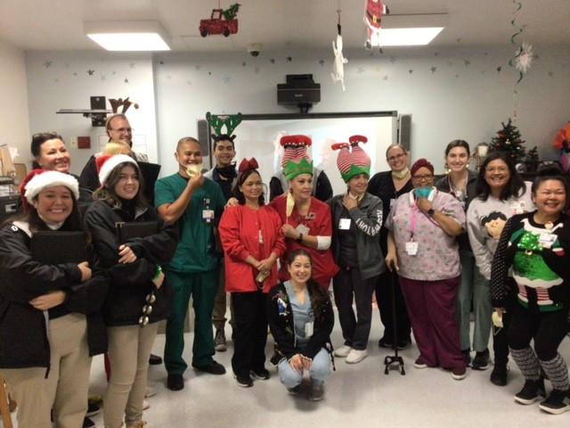 Whittier Staff taking a picture with some Cal High Student Christmas Carolers